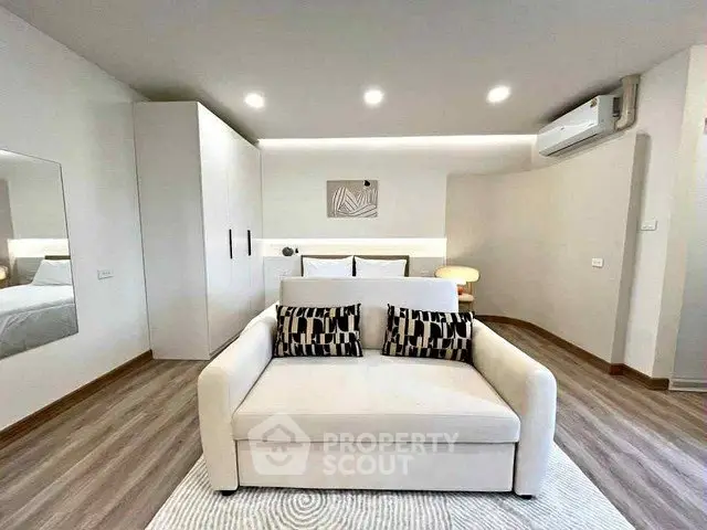 Modern bedroom with stylish decor and cozy seating area