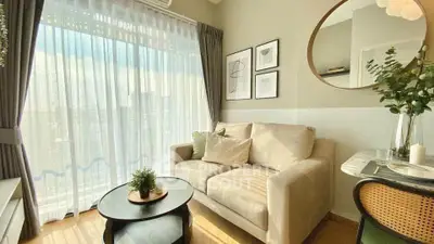 Bright and cozy living room with modern decor and large window view.