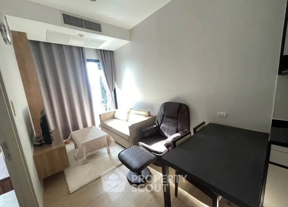 Cozy living room with modern furniture and natural light in a stylish apartment.