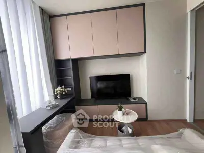 Modern living room with sleek cabinetry and large window, perfect for urban living.