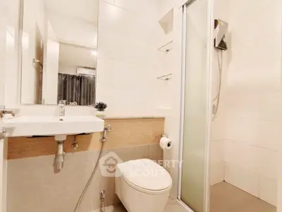 Modern bathroom with sleek fixtures and glass shower enclosure