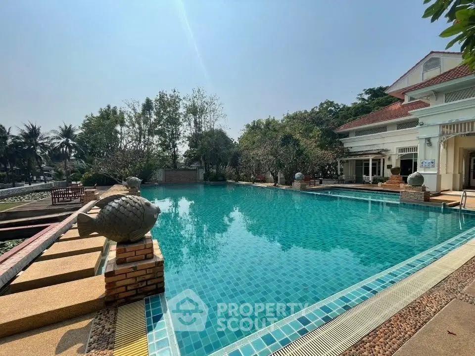 Luxurious outdoor pool area with clear blue water and elegant surroundings in a serene residential setting.