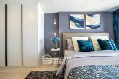 Modern bedroom with stylish decor and cozy bedding in a contemporary apartment.