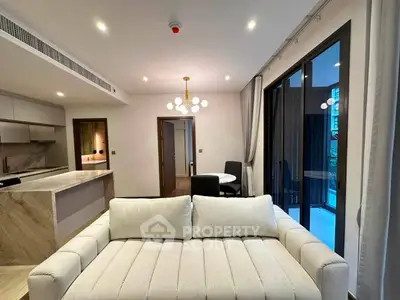 Modern living room with open kitchen and stylish lighting in luxury apartment