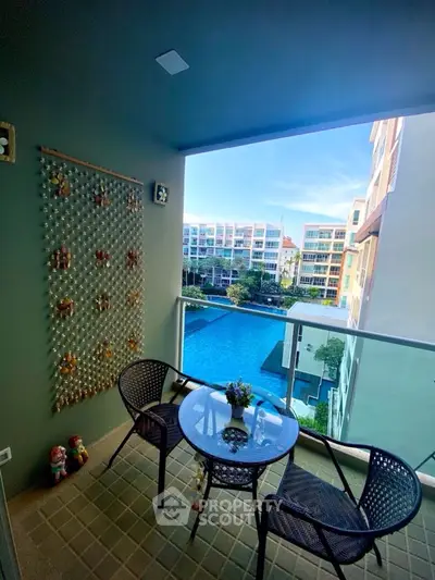 Charming balcony with pool view in modern apartment complex