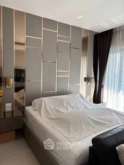 Luxurious bedroom with modern design and elegant decor, featuring a stylish headboard and large windows.