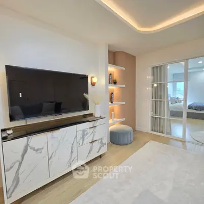 Modern living room with stylish marble TV stand and cozy decor