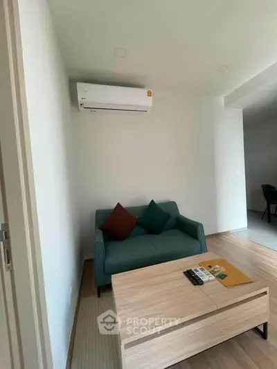 Modern living room with sleek sofa and air conditioning in a stylish apartment.