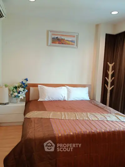 Cozy bedroom with elegant decor and warm lighting, perfect for relaxation.