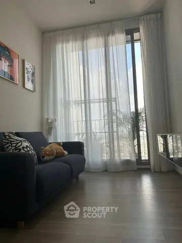 Cozy living room with large window and modern decor