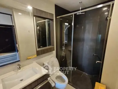 Modern bathroom with glass shower and sleek fixtures
