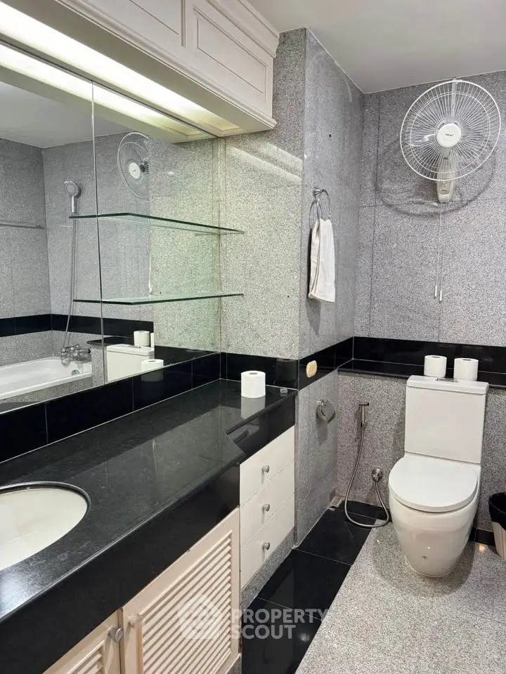 Modern bathroom with sleek granite countertops and elegant fixtures