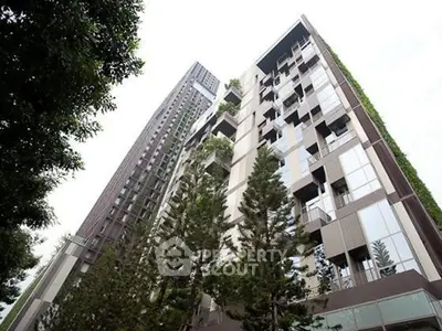 Modern high-rise building with lush greenery and sleek design