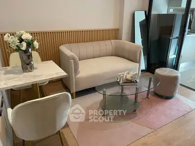 Chic modern living room with elegant sofa, glass coffee table, and stylish dining area.