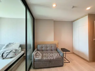 Modern bedroom with stylish sofa and sliding glass partition