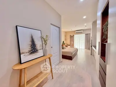 Spacious bedroom with elegant decor and natural light, featuring a cozy bed and stylish furnishings.