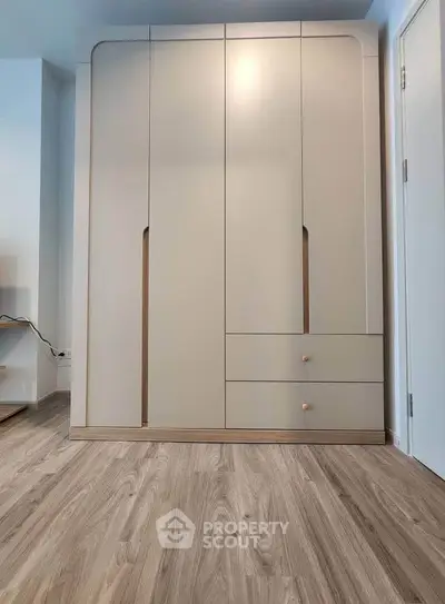 Modern minimalist wardrobe in a stylish bedroom with wooden flooring