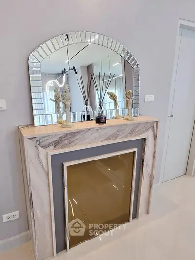 Elegant interior with decorative fireplace and mirror in modern living space.