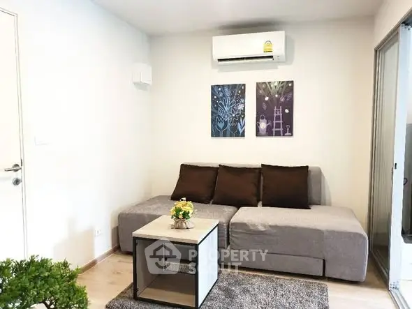 Modern living room with cozy sofa and air conditioning in a stylish apartment.