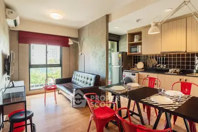 Modern open-layout living room and kitchen with stylish decor and natural light.