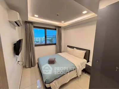 Modern bedroom with city view, featuring sleek design and cozy ambiance.