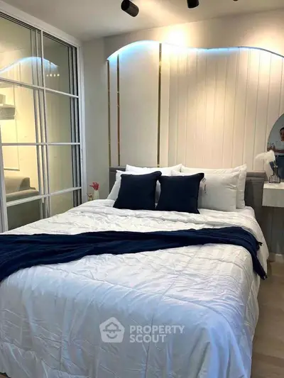 Modern bedroom with elegant design and cozy ambiance, featuring stylish bedding and soft lighting.