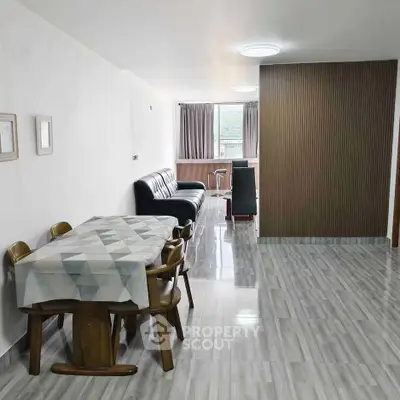 Spacious modern living room with elegant dining area and sleek flooring