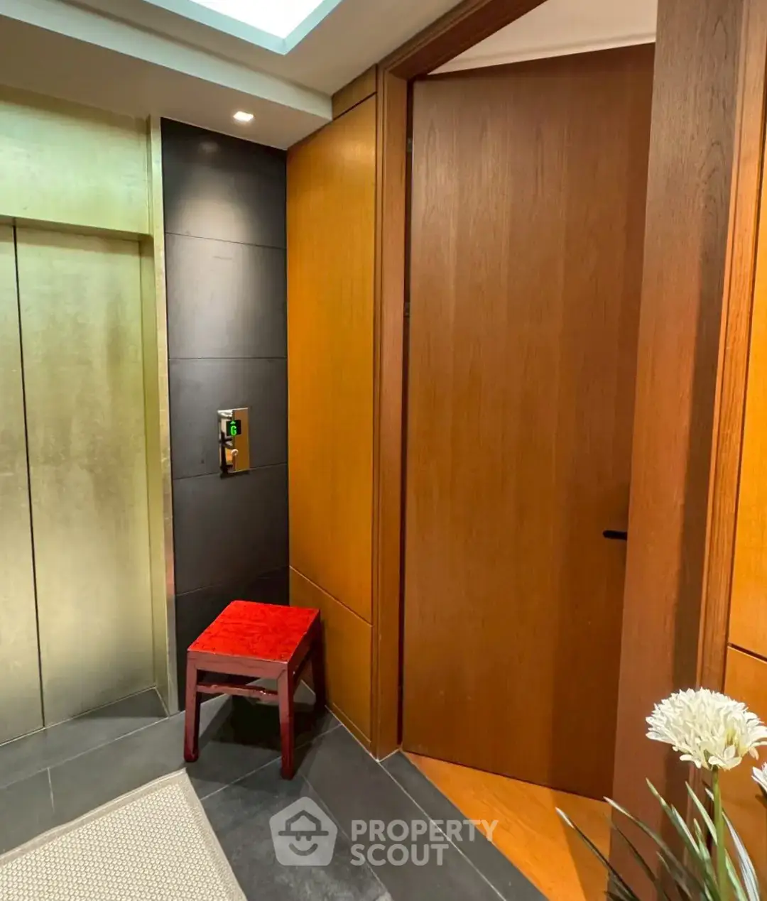 Elegant elevator lobby with modern design and wooden accents