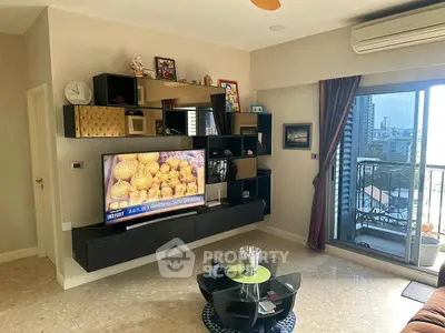 Modern living room with stylish TV unit and balcony view in urban apartment