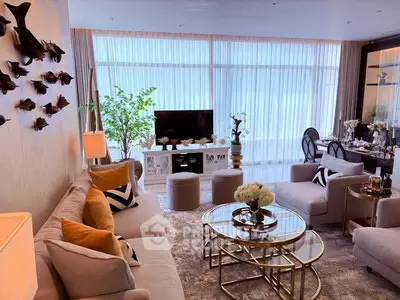 Luxurious living room with elegant decor, plush seating, and large windows offering abundant natural light.
