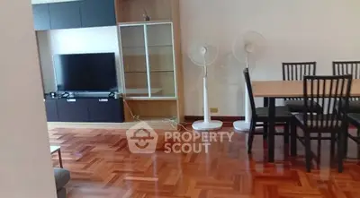 Spacious living room with elegant wooden flooring and modern furniture
