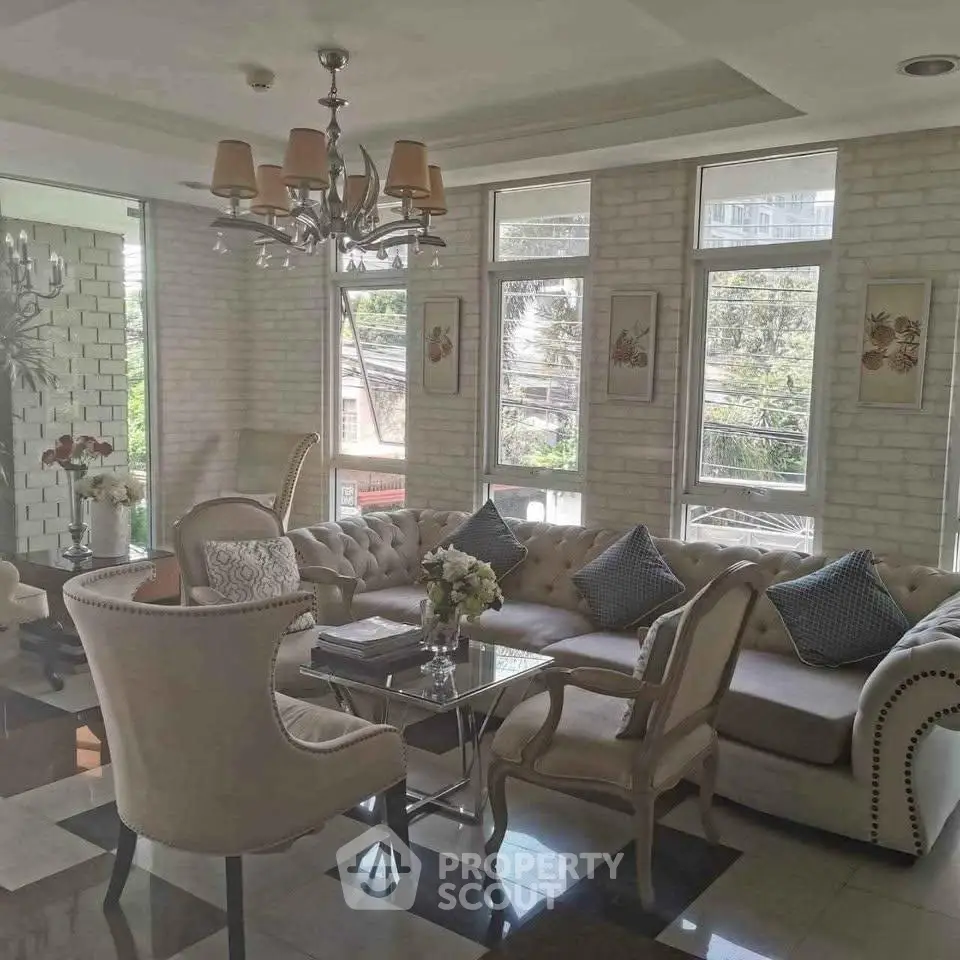 Elegant living room with plush seating and natural light in a modern apartment.
