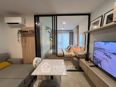 Modern open-plan living room with stylish decor and cozy bedroom view