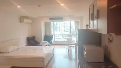 Spacious studio apartment with modern furnishings and city view