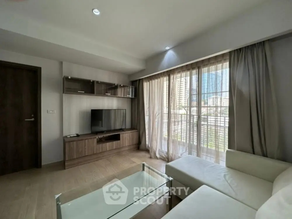 Modern living room with large window and stylish furniture in a contemporary apartment.