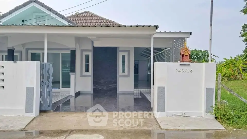 Charming single-story house with modern facade and spacious driveway