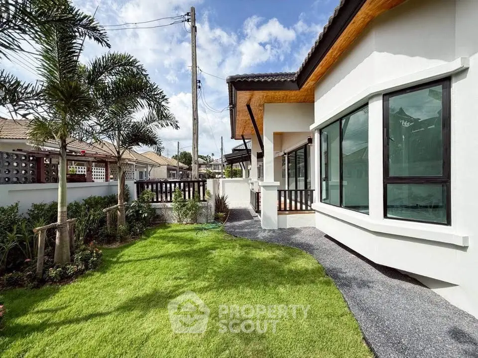 Charming modern house with lush green garden and stylish exterior design.