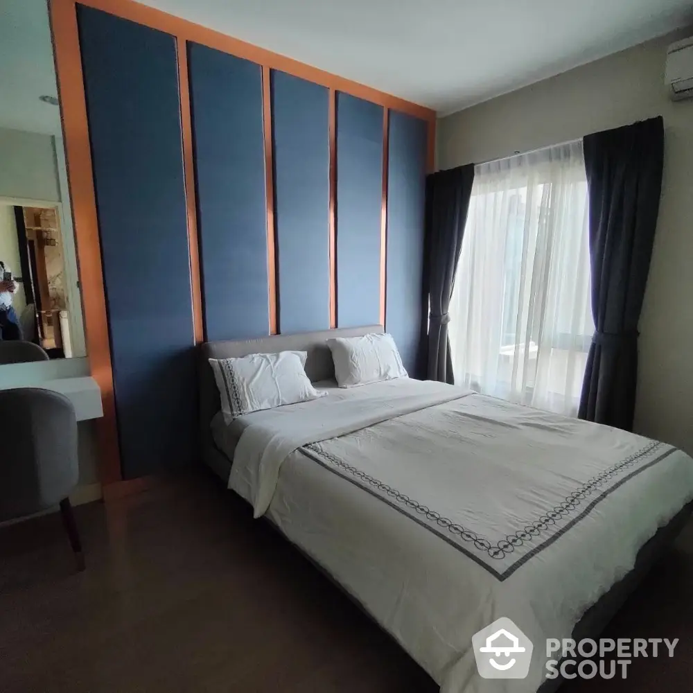 Modern bedroom with stylish accent wall and cozy bedding