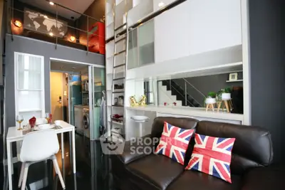 Modern loft apartment with stylish decor and mezzanine level, featuring a cozy living area and compact kitchen.
