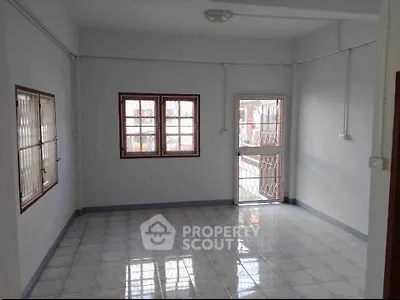 Spacious unfurnished room with tiled flooring and large windows, perfect for customization.