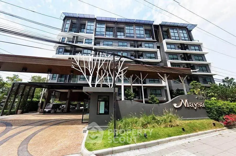 Modern condominium building with stylish entrance and lush landscaping