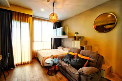 Modern studio apartment with cozy living area and loft bed