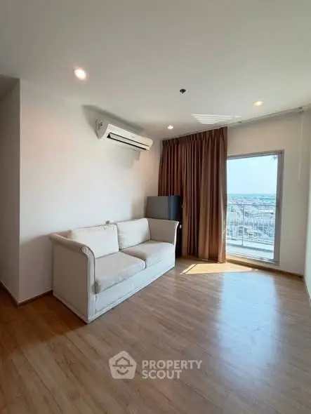 Bright living room with cozy sofa and city view, perfect for relaxation.