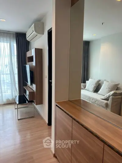 Modern living room with sleek furniture and natural light, perfect for urban living.