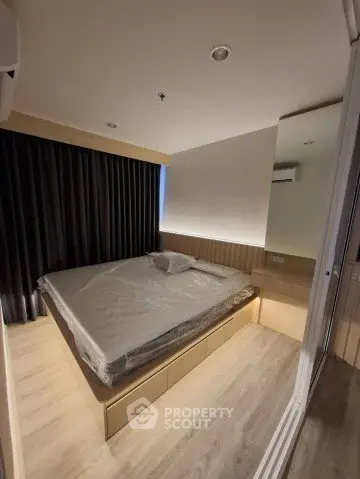 Modern bedroom with sleek design and ample storage in a contemporary apartment.