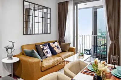 Stylish living room with cozy sofa and balcony view in modern apartment.
