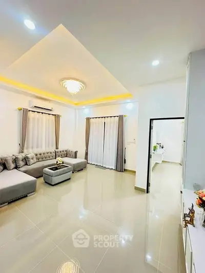 Spacious modern living room with elegant lighting and plush seating