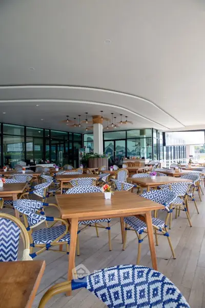 Chic outdoor dining area with stylish seating and modern design, perfect for entertaining guests.