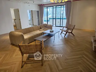 Spacious modern living room with elegant parquet flooring and city view balcony.