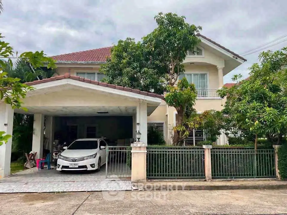 Charming suburban house with carport and lush greenery, perfect for family living.